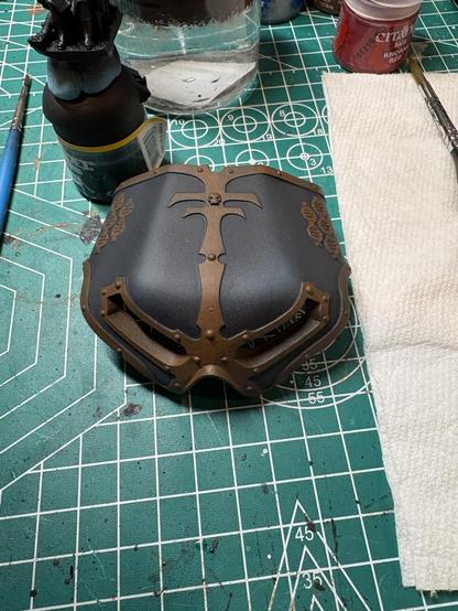 The reaver Titan mask. The metallic trim has been blocked in with a warm brown color.