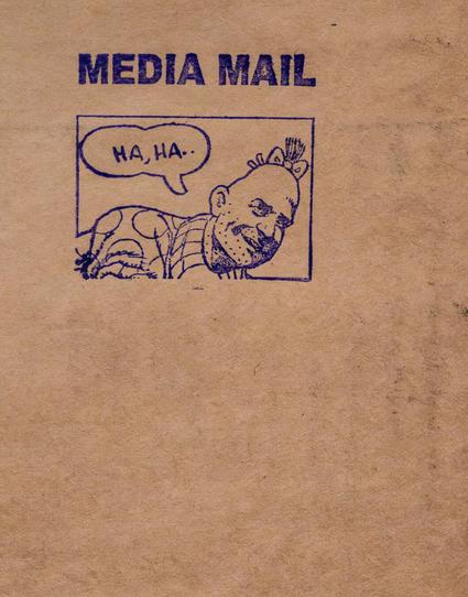 The photo's entire background is brown paper, as used to be common for wrapping packages to be mailed.  On it we see, rubber-stamped, the words MEDIA MAIL above a box.  The box is mostly filled with the head and shoulder of Zippy the Pinhead.  In  speech bubble, Zippy is saying "HA, HA.."