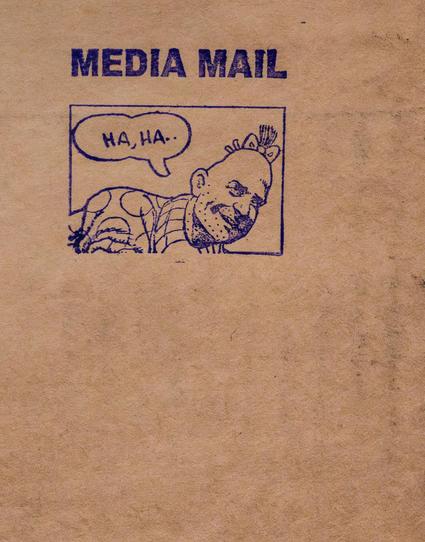The photo's entire background is brown paper, as used to be common for wrapping packages to be mailed.  On it we see, rubber-stamped, the words MEDIA MAIL above a box.  The box is mostly filled with the head and shoulder of Zippy the Pinhead.  In  speech bubble, Zippy is saying "HA, HA.."