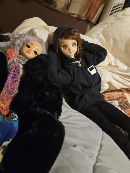Lily and the new doll laying on a bed together