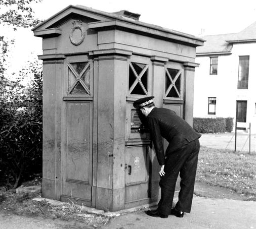A police officer demonstrating the use of the Speakerphone unit. Opening the box door automatically connected the phone to the headquarters switchboard. Photo via Lothian & Borders Police Wordpress.