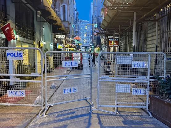 Lockdown fences with polis written on them blocking a street