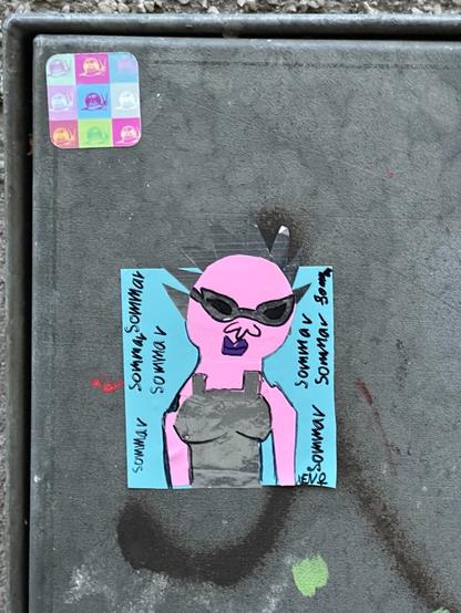 A sticker with a drawing of what looks like a female punk goblin in a tank top, made of a collage of blue, pink and silver. The figure’s spikes extend off the square of the sticker. Handwritten text around the sides reads, repeatedly, “sommar”