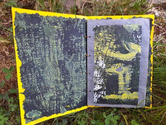 #1 All photos show double pages. At the left visible is the inside of the cover: abstract white and yellow maize print on black tissue paper. The first page shows an abstract composition of such a print with yellow acrypic painting. It's also on black tssue paper - glued to blue krafft paper. This krafft paper was the background for all pages.