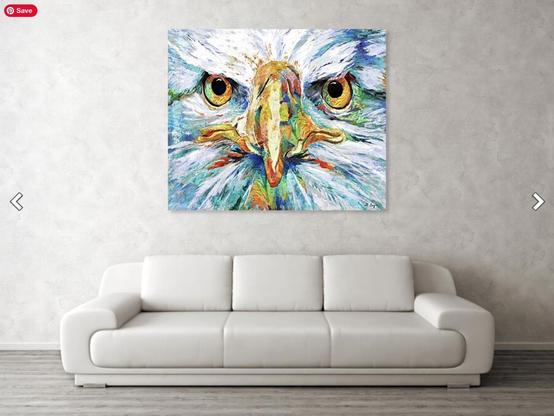 Colorful bald eagle face in a unique style over a white sofa by Sharon Cummings, artist.