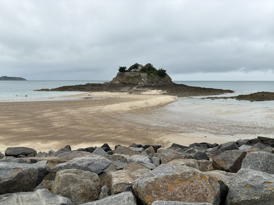 A fortification (Fort du Guesclin) sitting on a small island during low tide reachable by foot