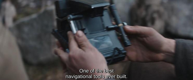 Firsr screen shot of a scene from the Andor series, in which the character Nemik shows an old model of navigational to Andor, the main character, and explains to him: "One of the best navigational tools ever built." The screenshot is a close-up on Nemik's hands holding the device.