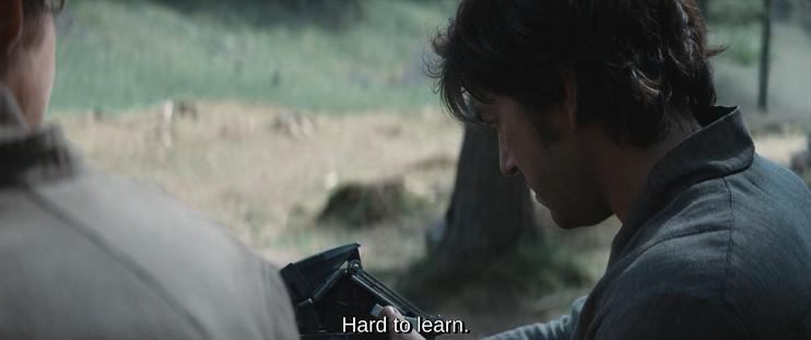 Third screenshot, focusing on the back of Andor holding and looking at the device, saying: "Hard to learn."