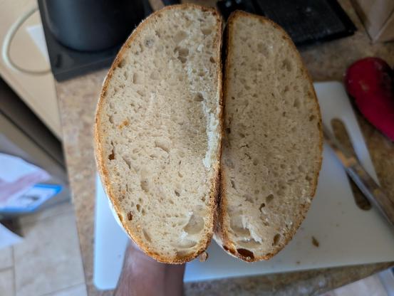 A cut open loaf of sourdough bread