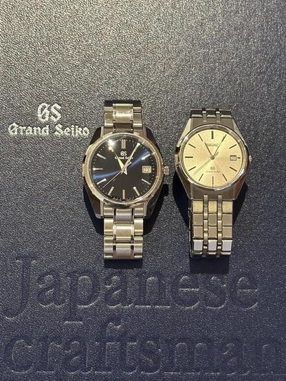 SBGP005 and 9587-8000/SBGS003 displayed on the blue cover of a book about Grand Seiko. Visible text of the cover reads: “GS Grand Seiko Japanese craftsmanship”.