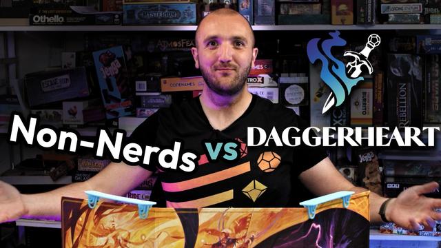 A YouTube thumbnail showing me, (shaved hair, stubbly brown beard, black t-shirt with rainbow dice) smiling happily sitting behind a game master's screen. The shelves behind me are covered in boardgames.

Text reads "Non-Nerds vs Daggerheart" with the Daggerheart logo.