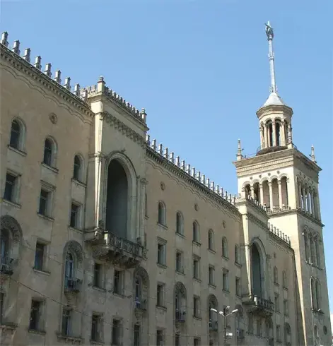The image appears to depict a large building with a distinctive architectural style. It features ornate details, including balconies and a tall tower with a spire. The building's facade is symmetrical and has multiple windows, giving it a grand appearance. It's likely a notable structure in a city, possibly serving a civic or institutional purpose. If you have specific questions about its history or function, feel free to ask!

Image Credits: Wikimedia / Monika from Sochaczew near Warsaw, Poland / CC BY-SA 2.0