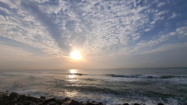 Sunrise over the Bay of Bengal today. Sky with scattered clouds and smudged sun. Happy Tuesday!
