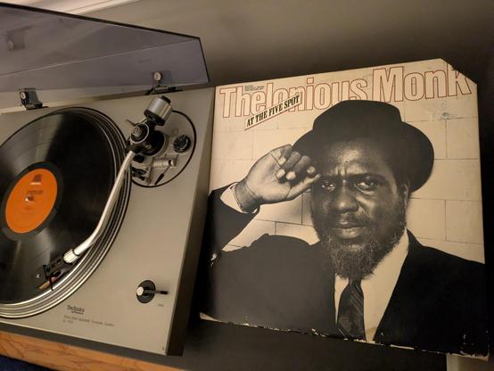 LP playing on turntable next to sleeve with cover photo of Monk