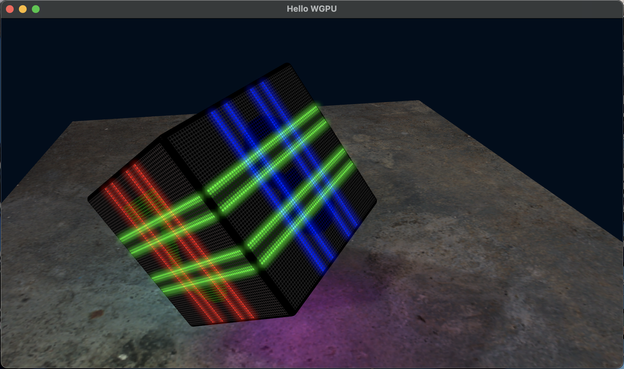 A black cube is floating above a stone/concrete slab.  The slab is moodily lit, and the cube has glowing bands of red, green, and blue wrapped around it in different directions.  The digit 2 is faintly visible on one face.  The red band is reflecting off the slab.  The cube is also casting diffuse shadows.