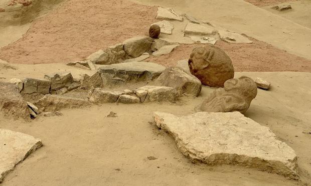 Stone foundations of dwelling with monumnetal head-shaped idols in situ