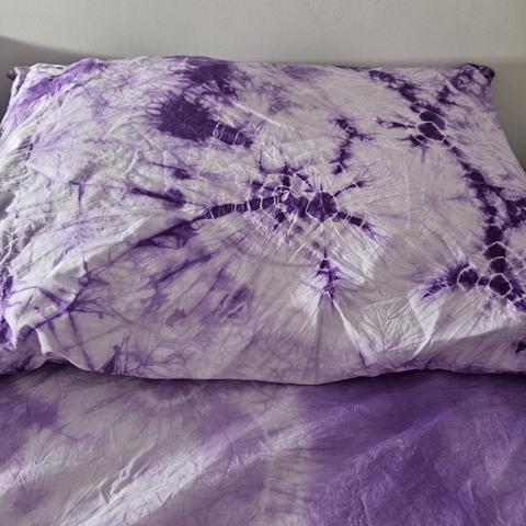 a pillowcase: mostly pale purple, with some spots of dark purple surrounded by thin pale rings