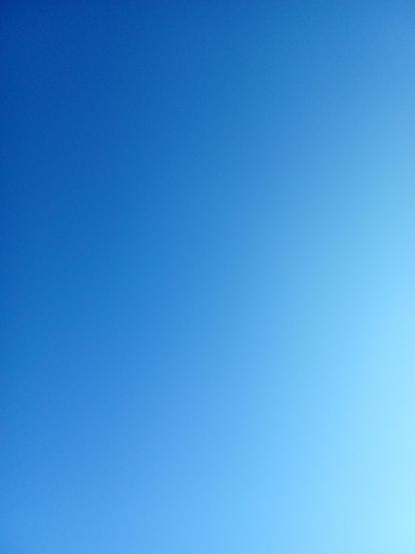 The blue sky. It is lighter on the right side because of the sun rising.