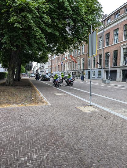Almost empty street, only filled with police motorcycles and armored cars.