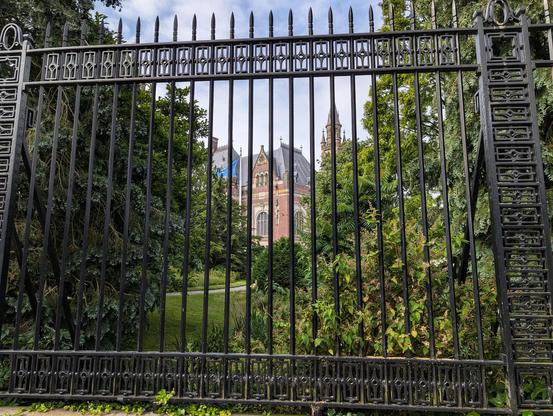 Building visible through an iron gate.