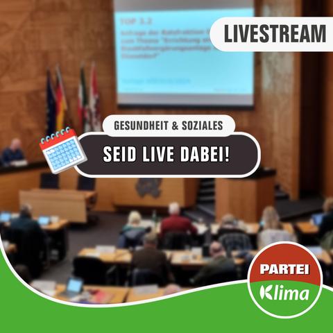 Zu sehen ist eine Totale des Plenarsaals unseres Düsseldorfer Rathauses. In einem weißen Kasten mit abgerundeten Ecken steht in schwarzer Sprache "Gesundheit & Soziales". Darunter steht in einem anthrazitfarbenen Kasten mit weißen Buchstaben: „Seid Live dabei!"