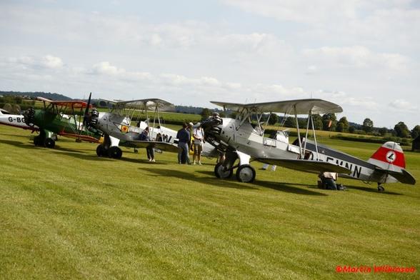 Three Focke-Wulf Stieglitzes lined up on the grass at Old Warden during a Shuttleworth display.