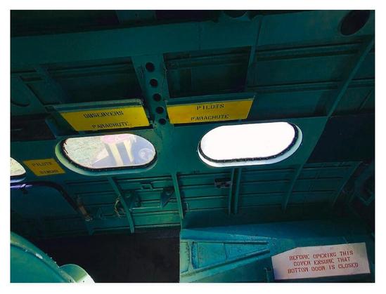 Colour photograph showing what looks like the interior of a miltary aircraft.