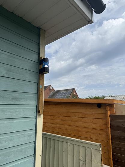 A pinhole camera fixed to the corner of a shed