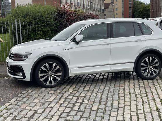 White SUV over parking on a pedestrian pavement.