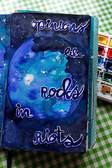 Artjournalpage in shades of pretty dark blue, in the middle a circle in lighter blue. Cut out, painted letters, saying: Opinions like Rocks In Riots. 

Quote from the song: No pressure over Cappuccino by Alanis Morissette.
"You can't fool me
They'll throw opinions like rocks in riots
And they'll stumble around like hypocrites
Is it just me, or is it dark in here?"