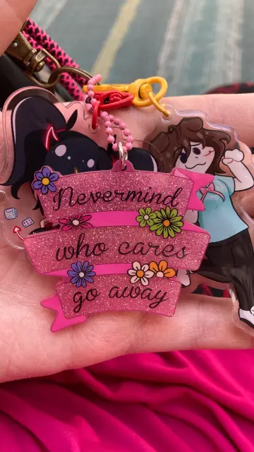 My new bag clip thats says "never mind, who cares, go away" with pink glitter and flowers