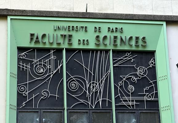 A doorway at a sorbonne science building featuring decorations that resemble the traces of particles in a bubble chamber, as made famous by that strokes album cover