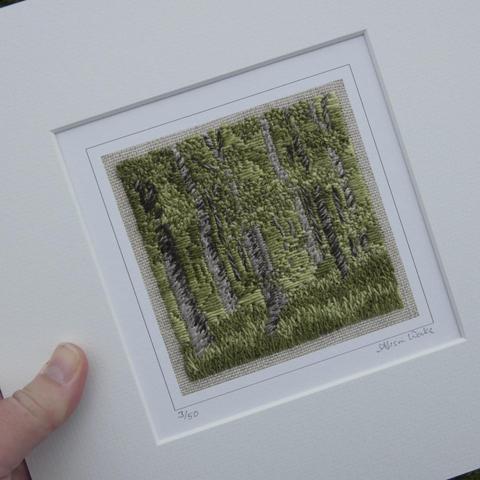 Print taken from stitched artwork depicting a summer woodland with light and shade. A very green pallette with tall thin tree trunks in brown/grey. Mounted in white and held in the artist's hand for scale (10x10" ext dims)