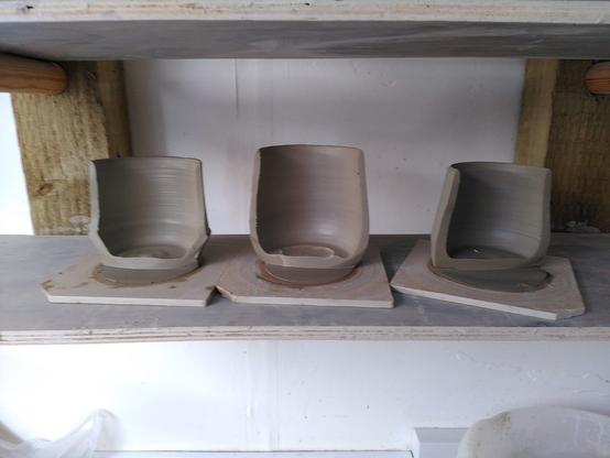3 thrown mug bodies cut in half exposing their regular rims