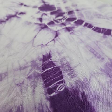 a pillowcase: another close-up of concentric pale rings on streaks of deep purple, the focus is on a section of deep purple with many lines of different sizes
