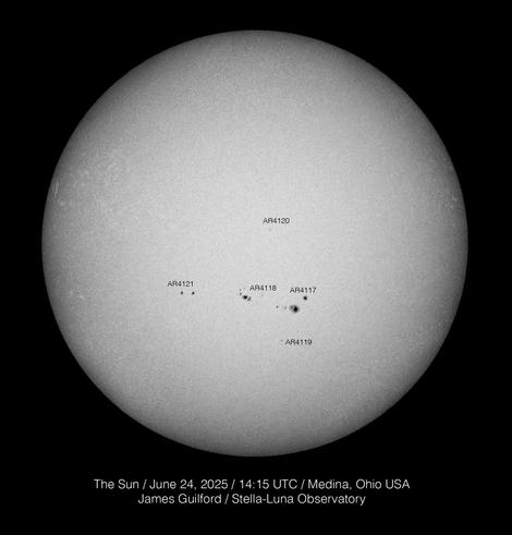 The sun appears as a gray/white disk on a black background.A series of dark sunspots run left to right , just below the sun's equator. Image recorded on June 24, 2025.