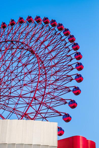 The iconic HEP FIVE ferris wheel in Osaka, Japan, with a blue sky in the background.