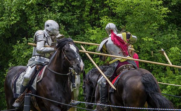 Knights in full armor joust at a bustling medieval faire in Toronto's Black Creek Pioneer Village.