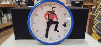 Whimsical wall clock with a blue rim featuring a dynamic illustration of William T Riker from Star Trek: The Next Generation.  The arms form the clock's hands, conveying energy and playfulness.