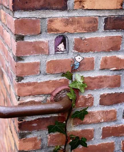 The artwork portrays two mice, one peeking from a small hole in a brick wall with purple curtains, and another climbing up an ivy vine towards the first. 