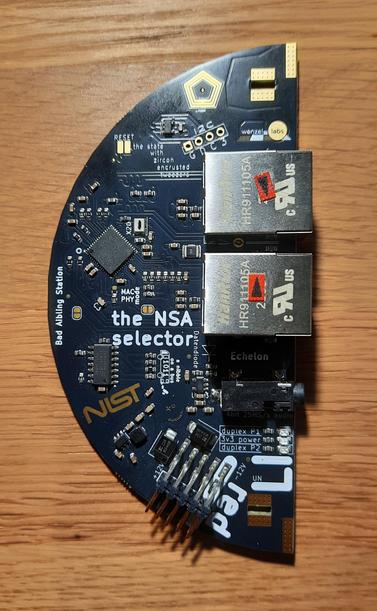 a half-circle shaped PCB with two ethernet jacks, labelled the "NSA selector", a eurorack module