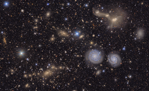 This image captures a small section of NSF–DOE Vera C. Rubin Observatory’s view of the Virgo Cluster, offering a vivid glimpse of the variety in the cosmos. Visible are two prominent spiral galaxies, three merging galaxies, galaxy groups both near and distant, stars within our own Milky Way, and much more.