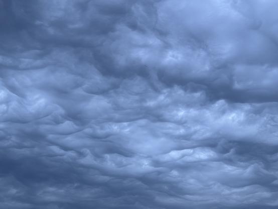 Underside of clouds, all grey and silver.