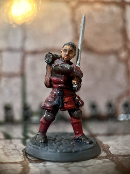 Female barbarian figure in red oriental style armour. She has a big sword and an attitude.