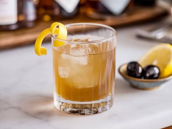Palomino drink in rocks glass with lemon twist