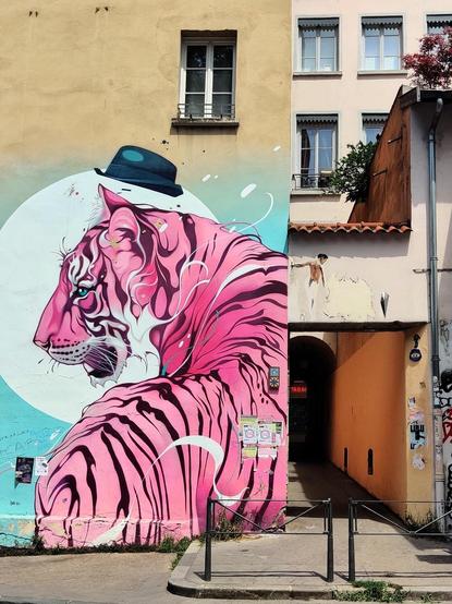 Graffiti de un tigre rosa con un sombrero negro en la rue de la Martinière.