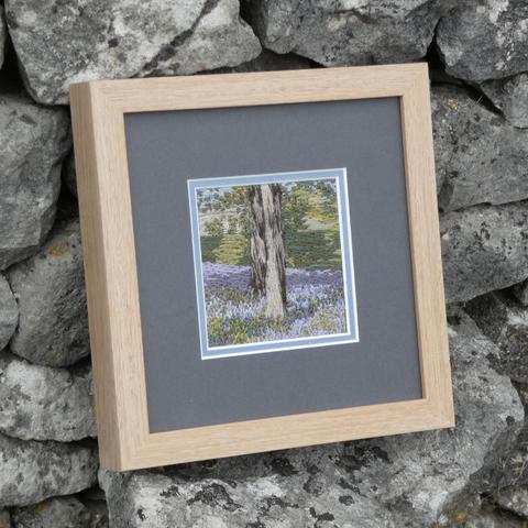 The same artwork leant against a stone wall and viewed from the left