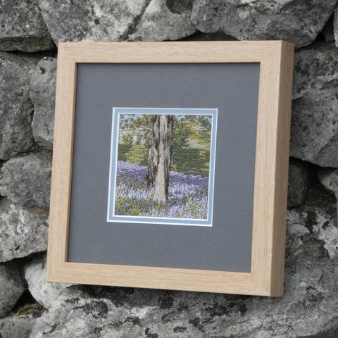 The same artwork leant against a stone wall and viewed from the right