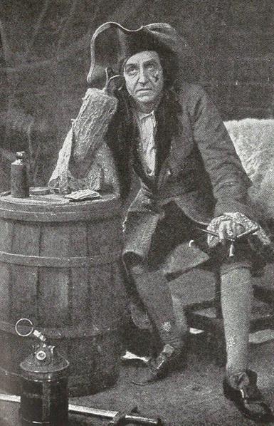 Captain Hook sits and thinks about his life. A photo of Robb Harwood in costume from a theatrical production of "Peter Pan."