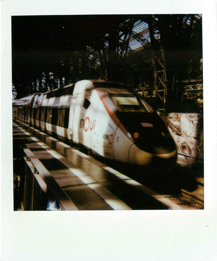 a polaroid picture of a french TGV train standing in a train station